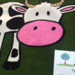 Cow graphic in fake grass
