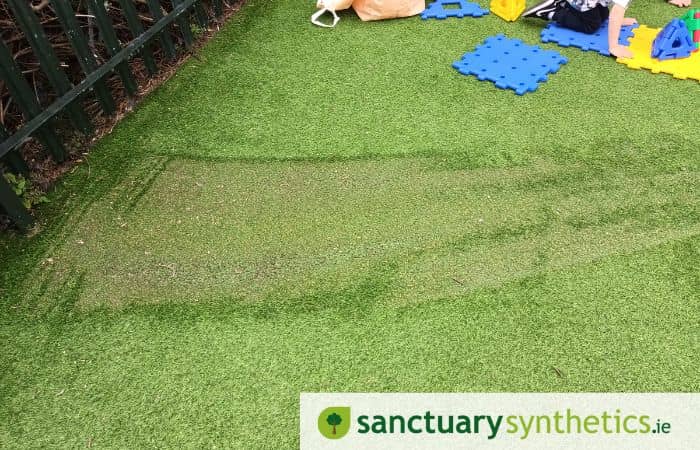 Artificial grass burn from reflection of glass on hot day