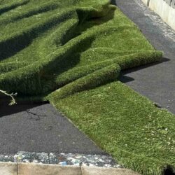 image of artificial grass not done correctly - lightly glued to underlay, not fixed to any frame